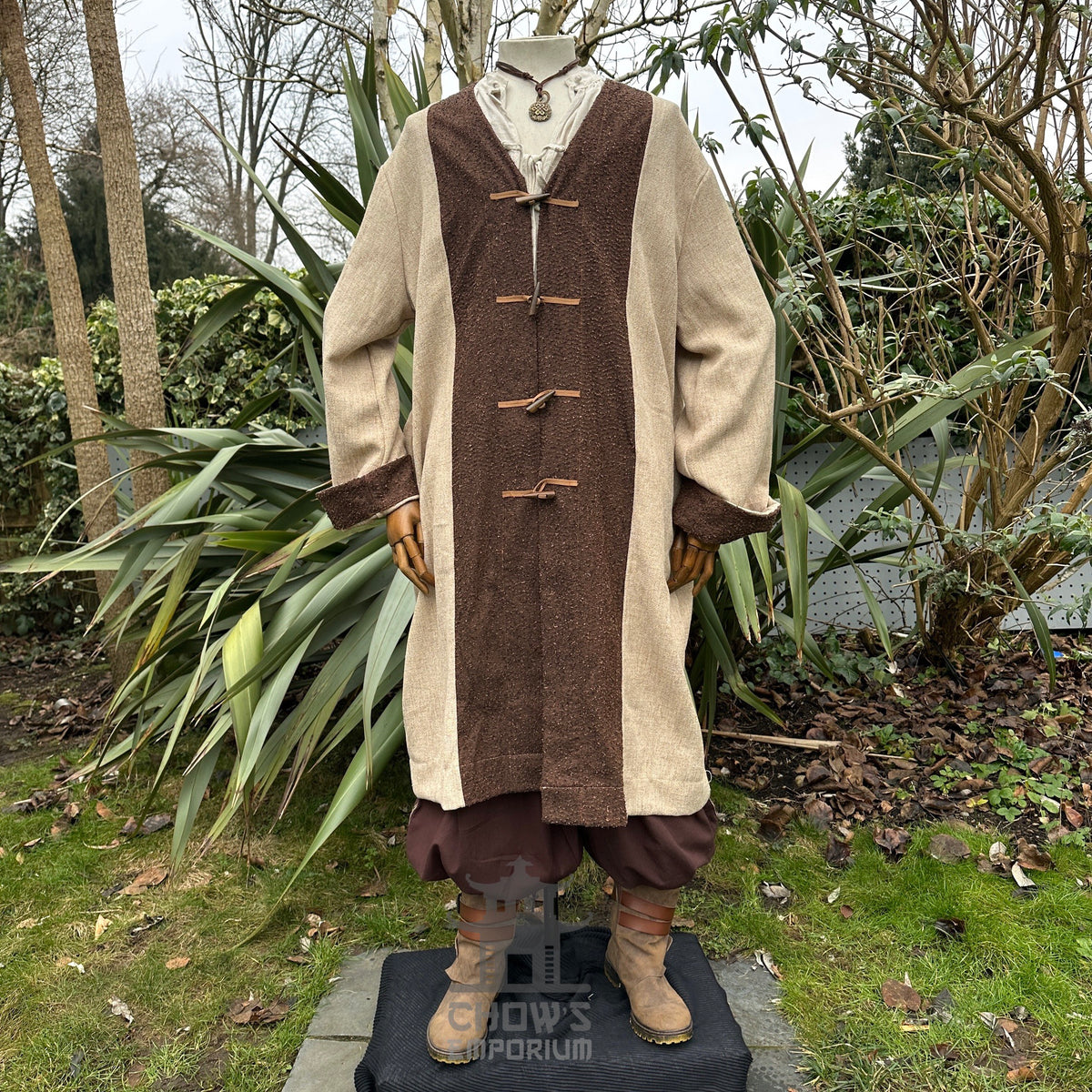 Medieval LARP healer outfit with beige robe, brown accents.