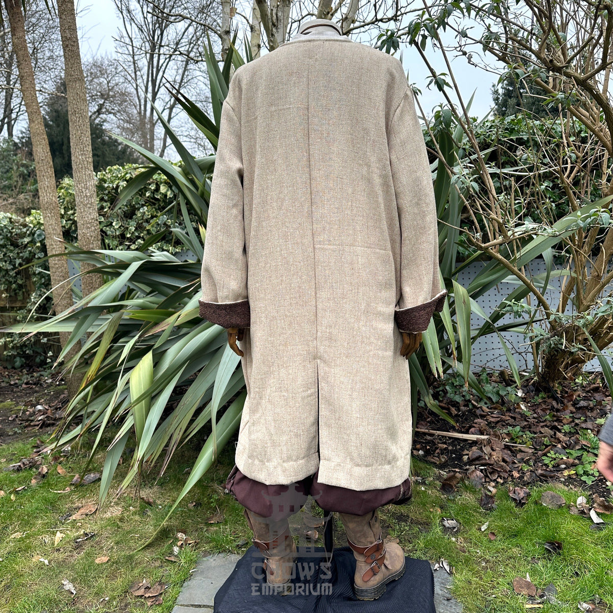 Light brown medieval LARP jacket, back view, with brown cuffed trousers.