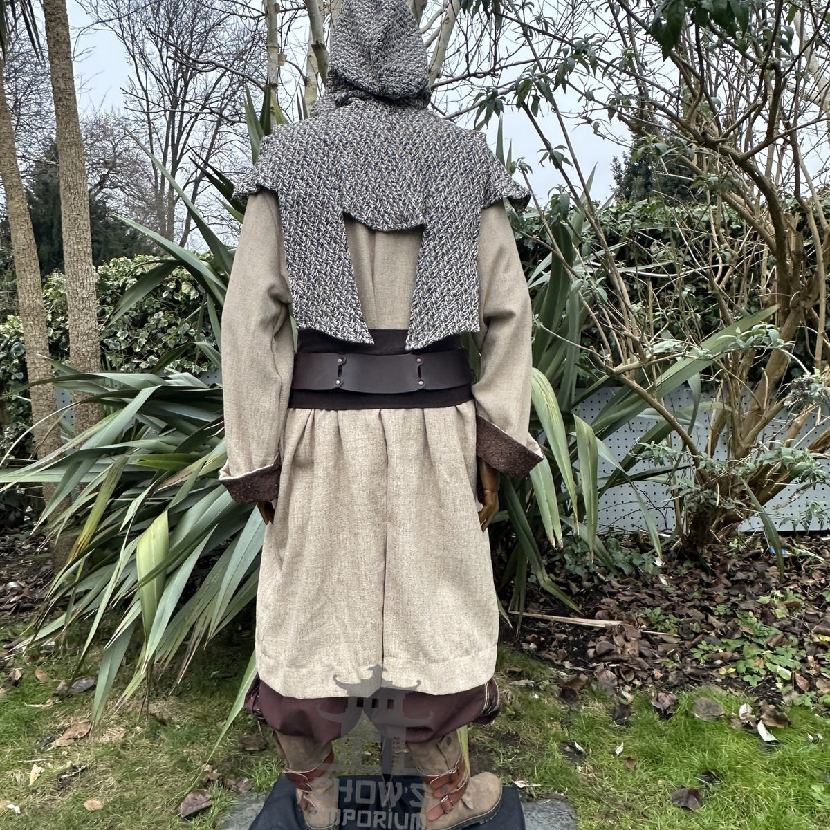 Back view of LARP set with beige jacket, grey hood, brown trousers.