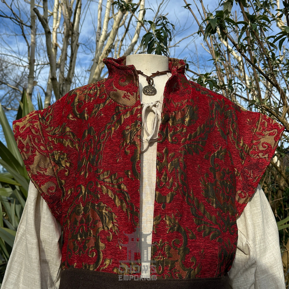Crimson waistcoat with leaf brocade.