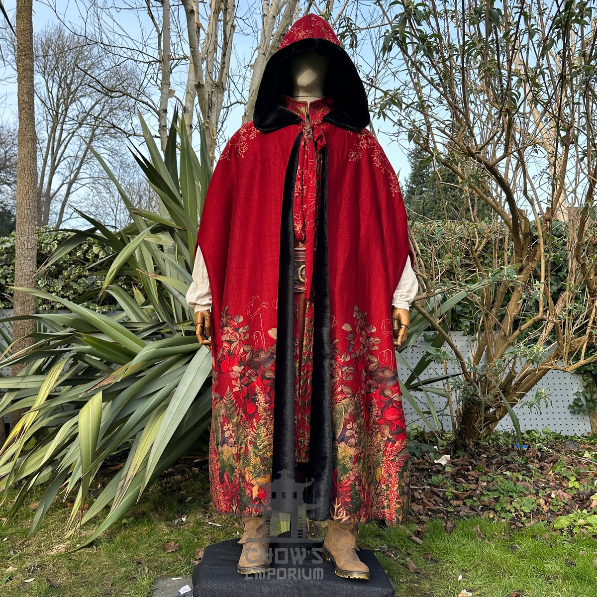 Mannequin in red hooded LARP cloak, floral hem.