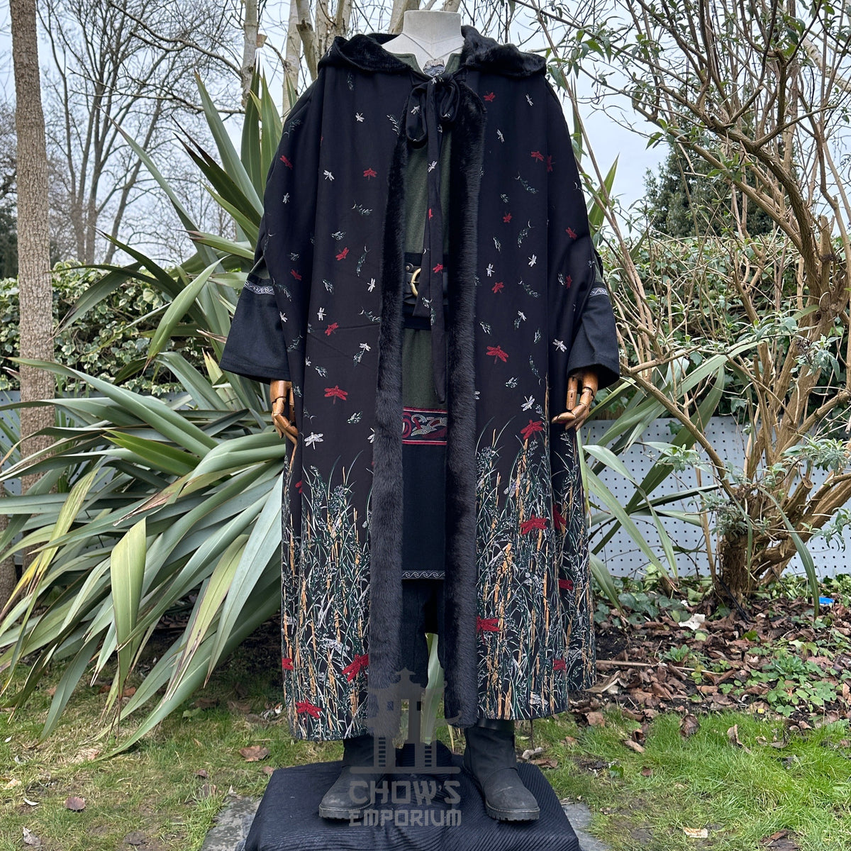 Black fur-lined cloak with medieval embroidery, displayed.