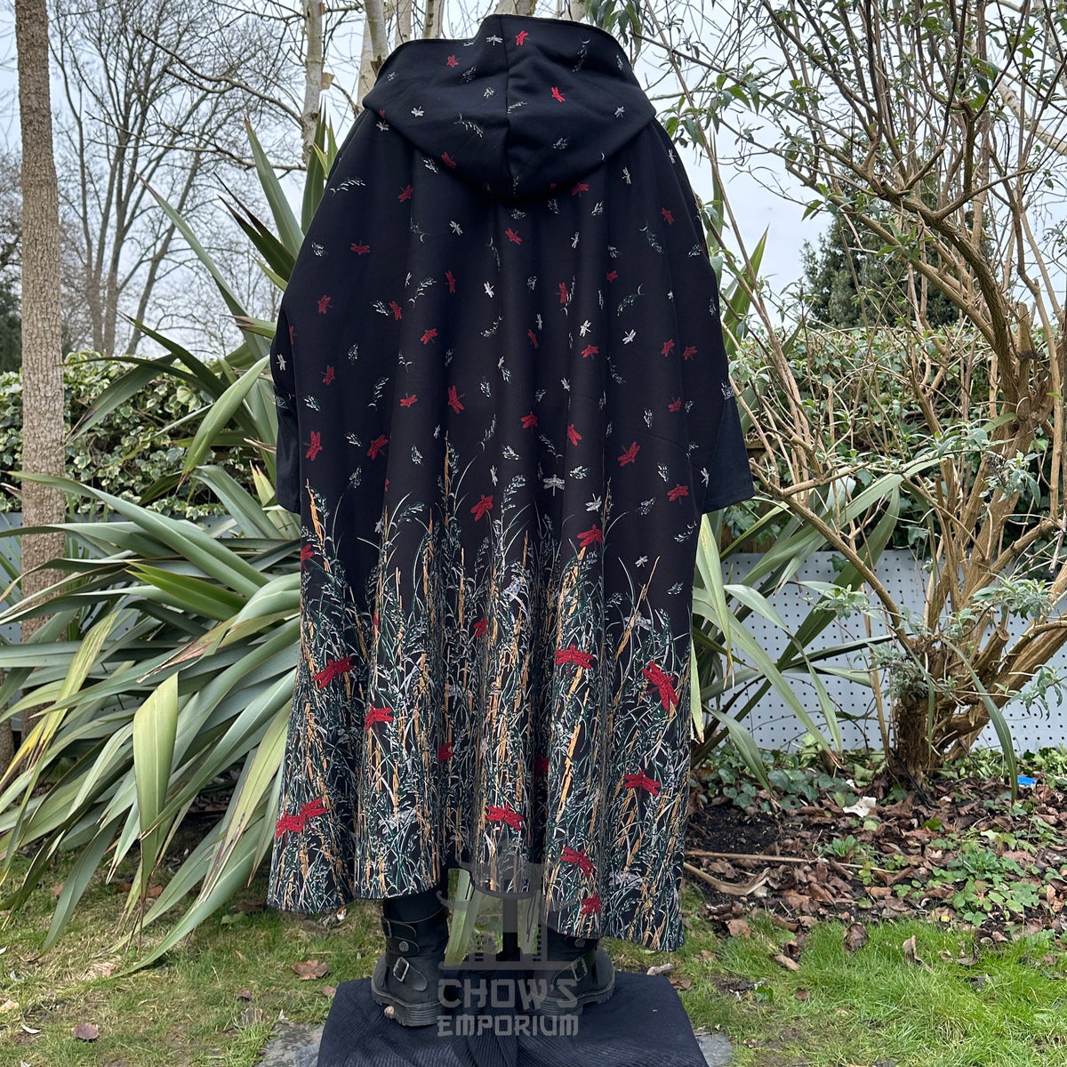 Black hooded cloak with intricate red and green design.