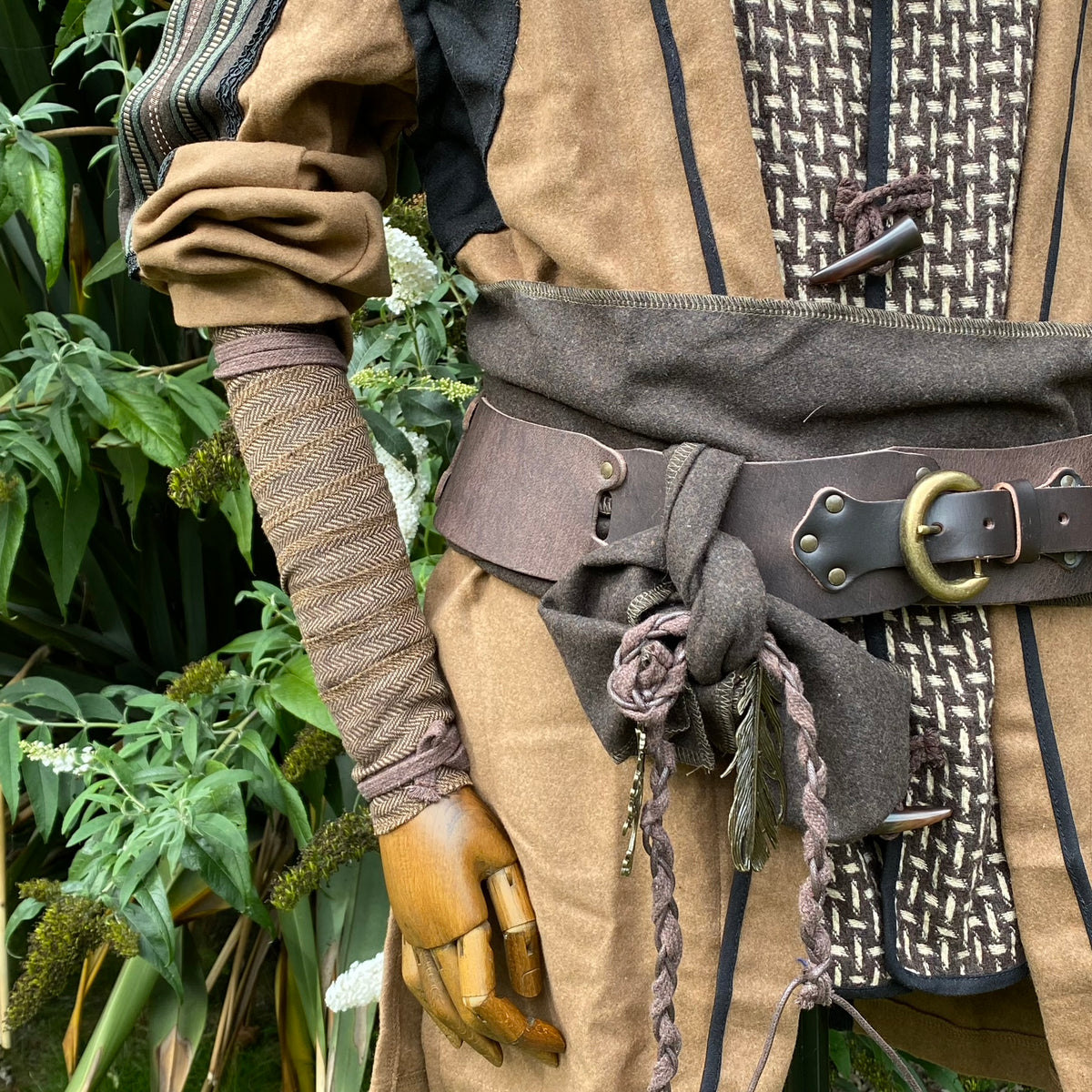 Dark brown herringbone wool arm wrap, medieval LARP costume detail.