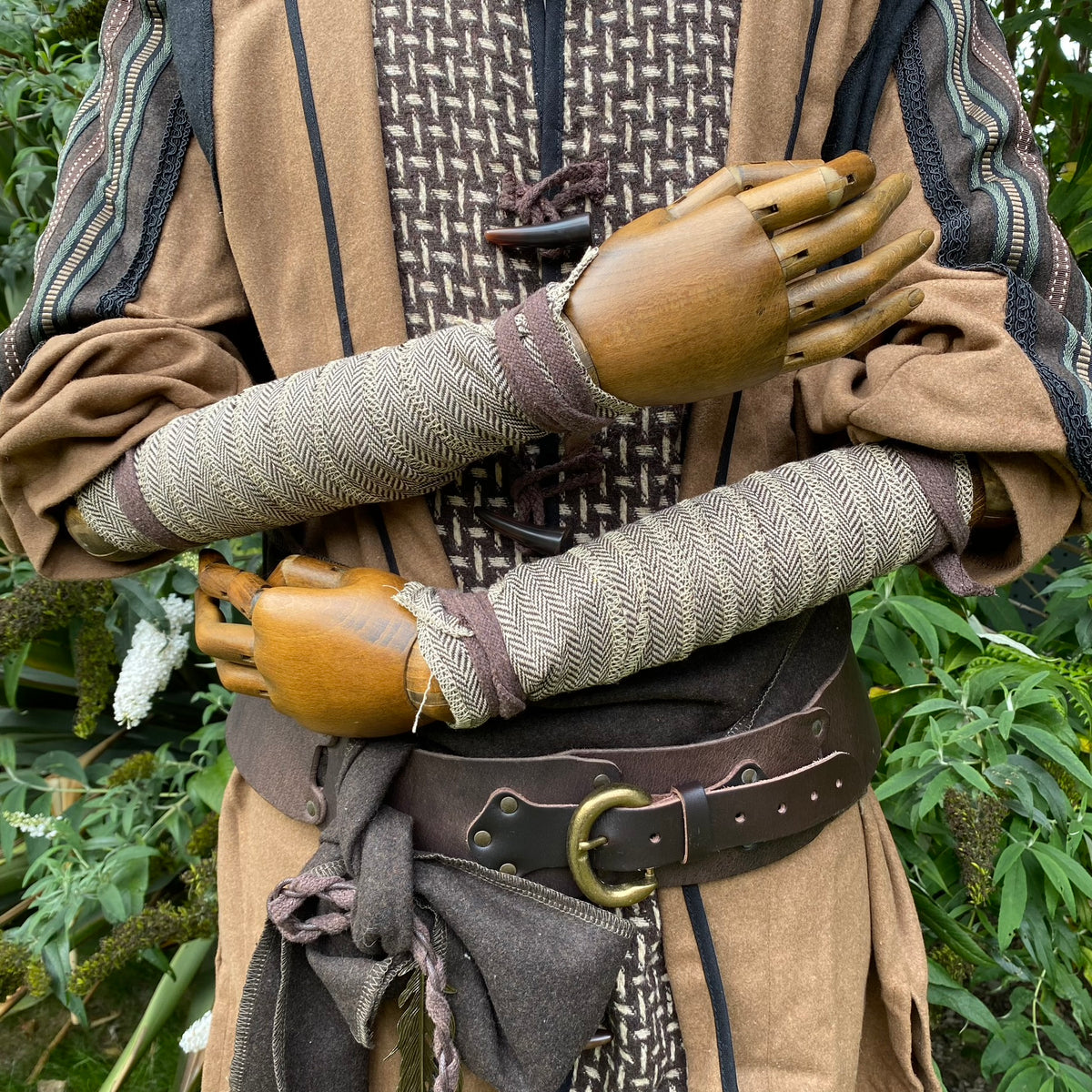 Light brown herringbone wool wraps for LARP, medieval arm detail.
