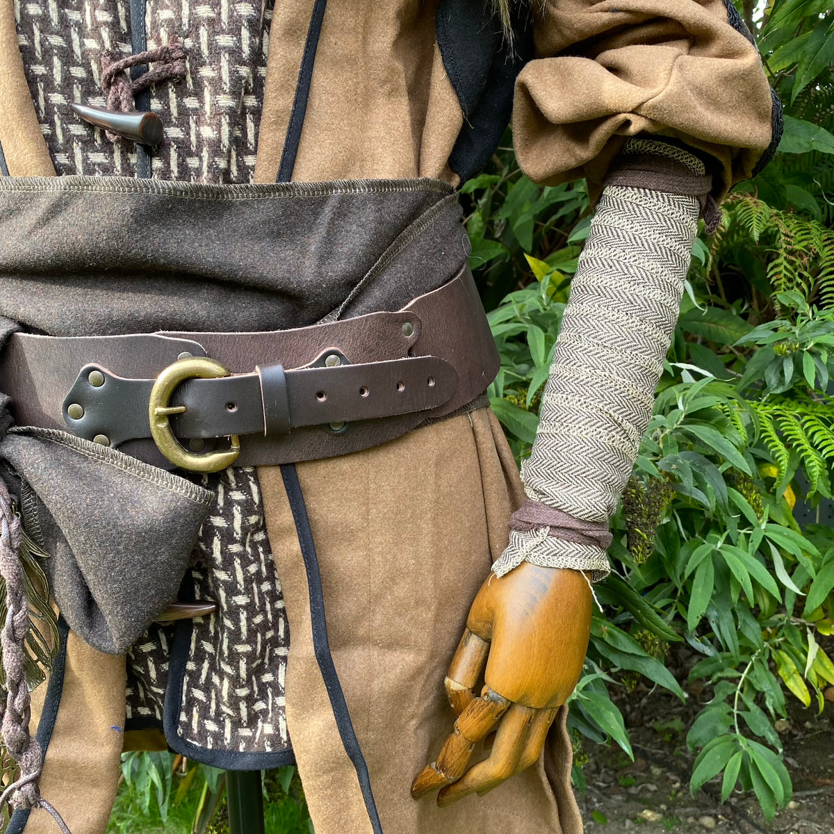 Light brown herringbone wool arm wrap on mannequin, medieval style.