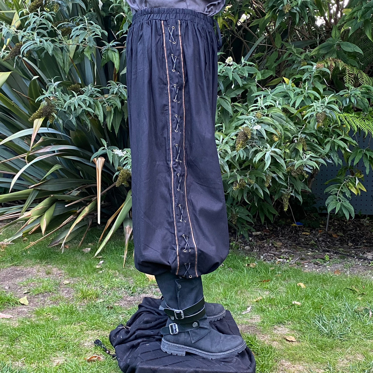 Black LARP medieval pants with side lace detail seen.