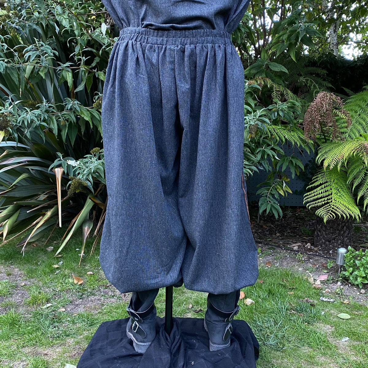 Back view of grey wool hero trousers with elastic waistband and reinforced stitching.