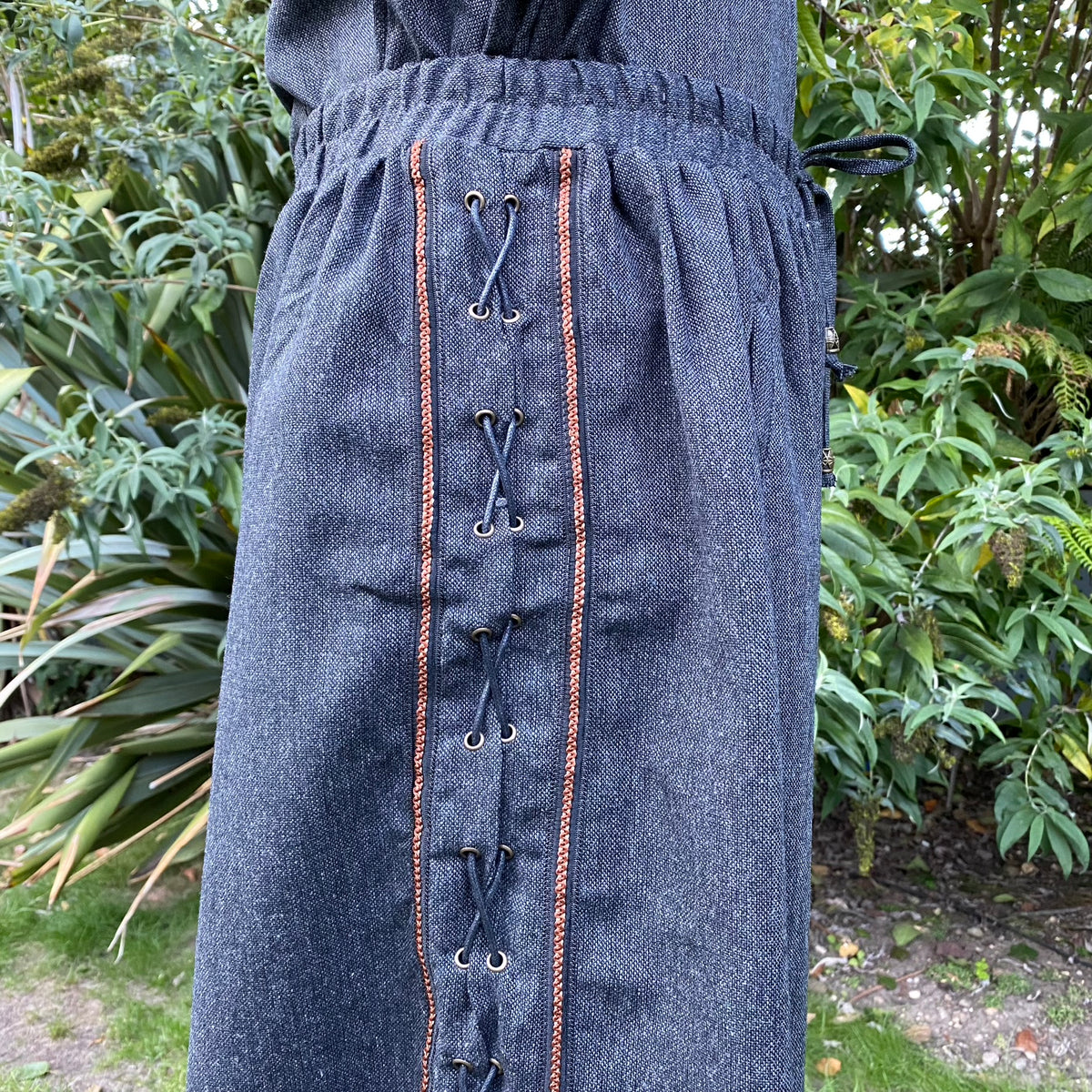 Side view of grey wool LARP pants with detailed side lacing.