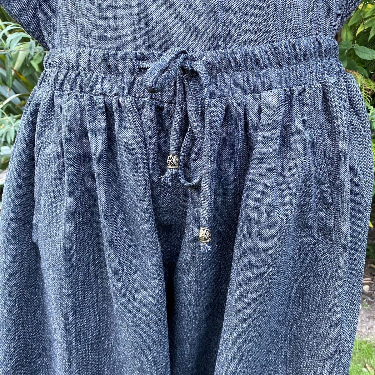 Close-up detail of drawstring on grey wool LARP hero pants.