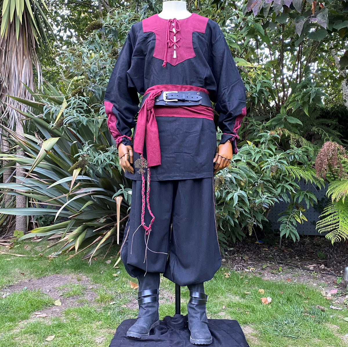 Crimson and black LARP outfit with hood, belt, and sash.