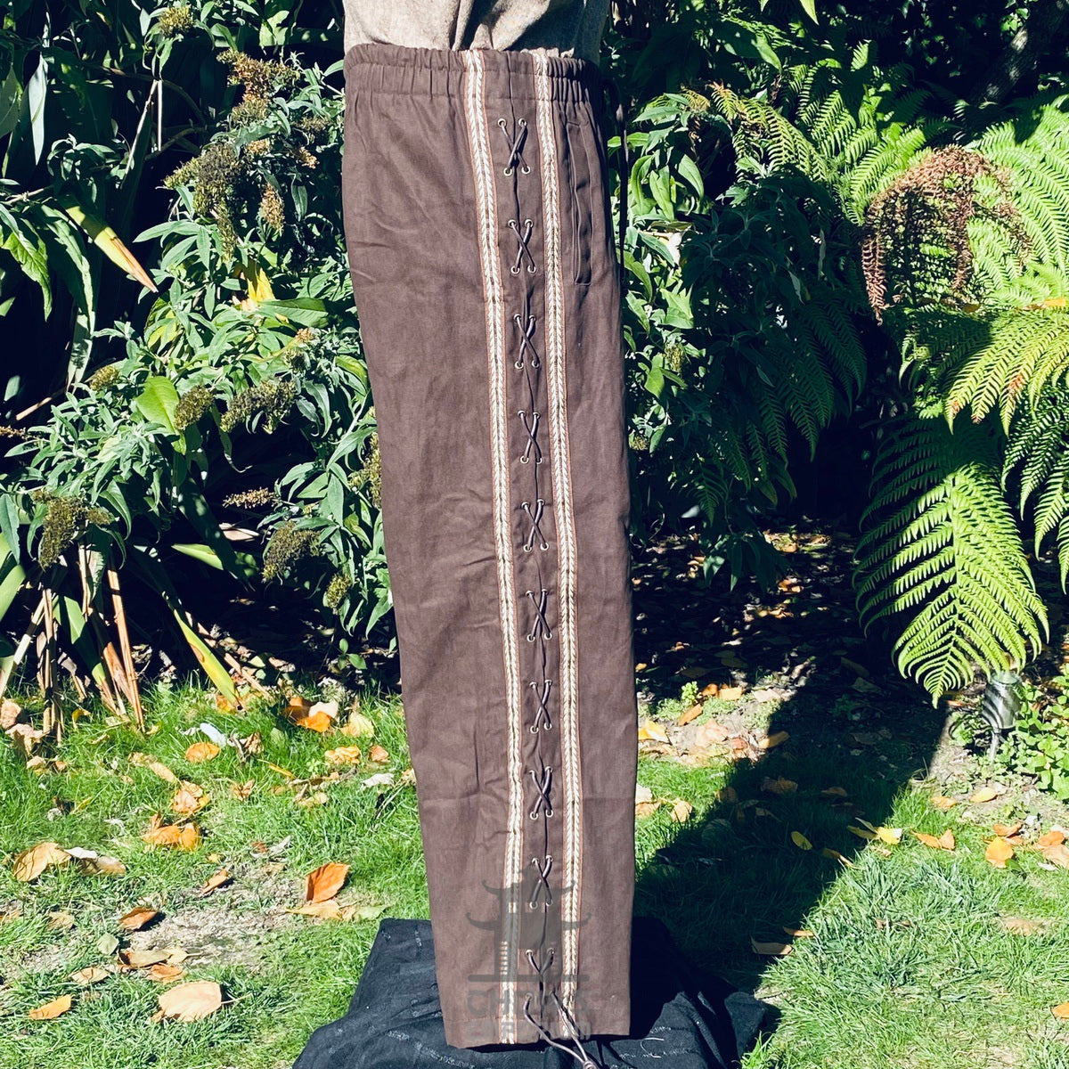 medieval straight leg cotton pants with decorative braiding.