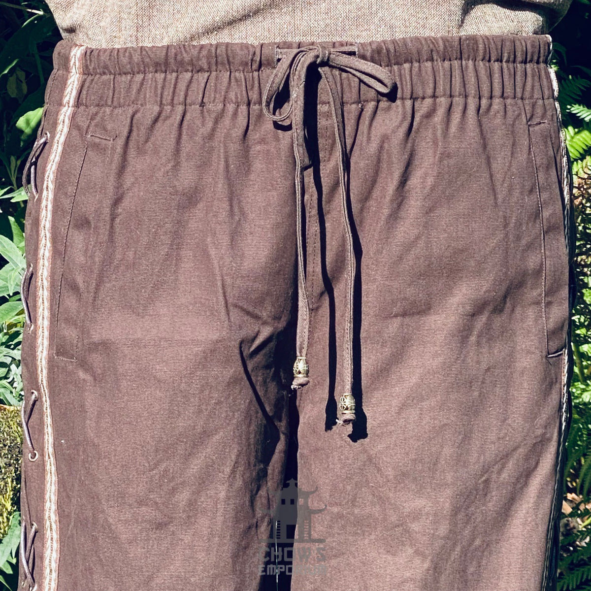 drawstring detail brown larp trousers with side lacing.