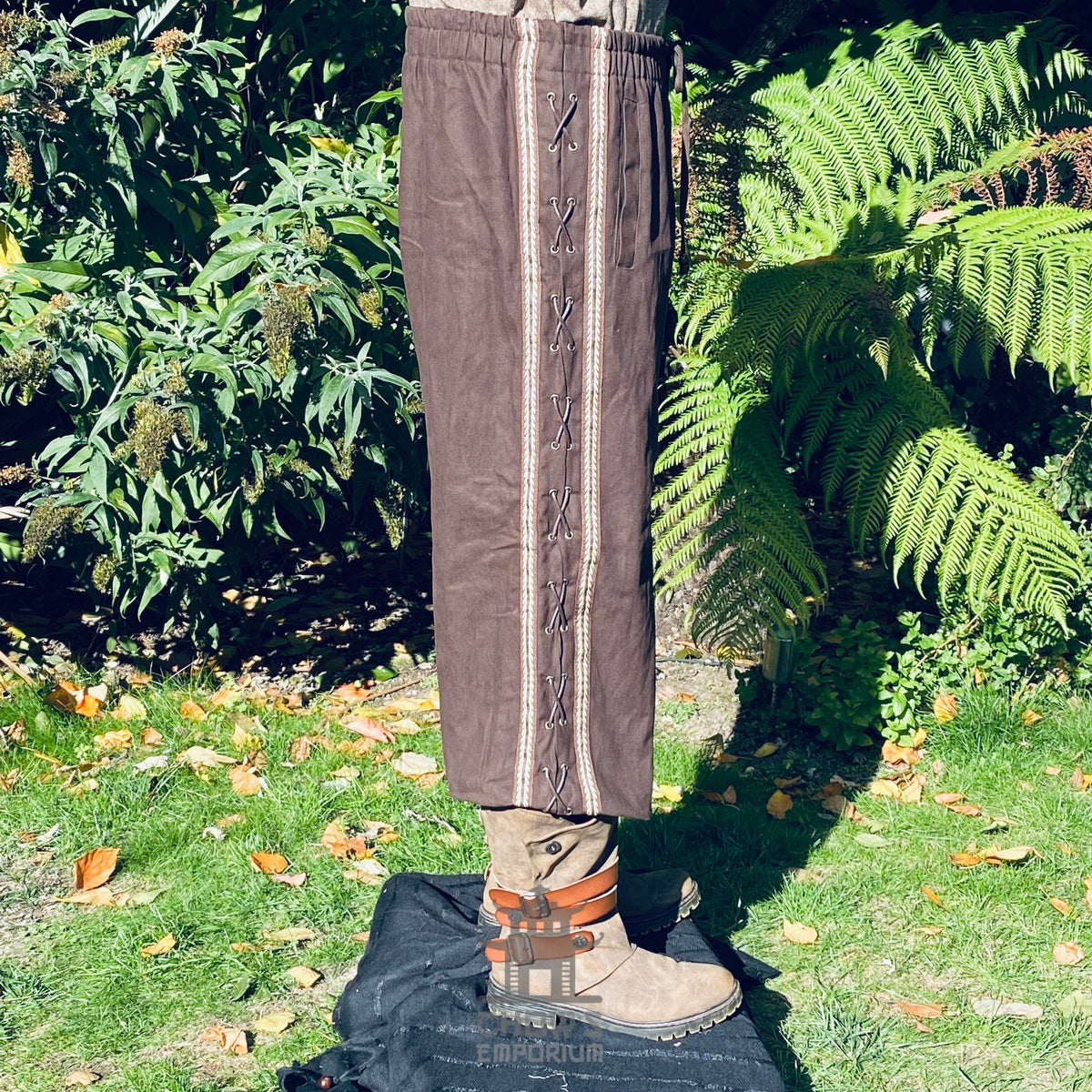 brown cotton medieval pants with side lacing and braiding.
