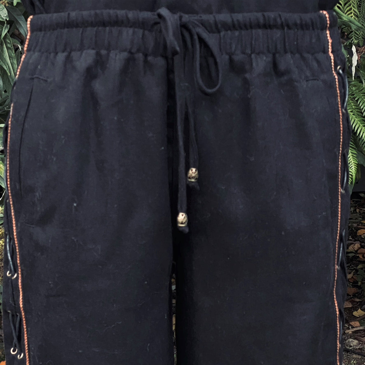 Black LARP wool pants with frontal waist detail and side lace.