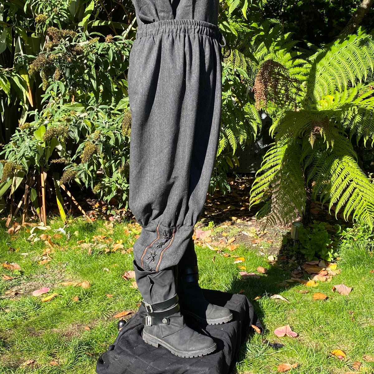 Profile of grey LARP Viking pants featuring calf embroidery detail.