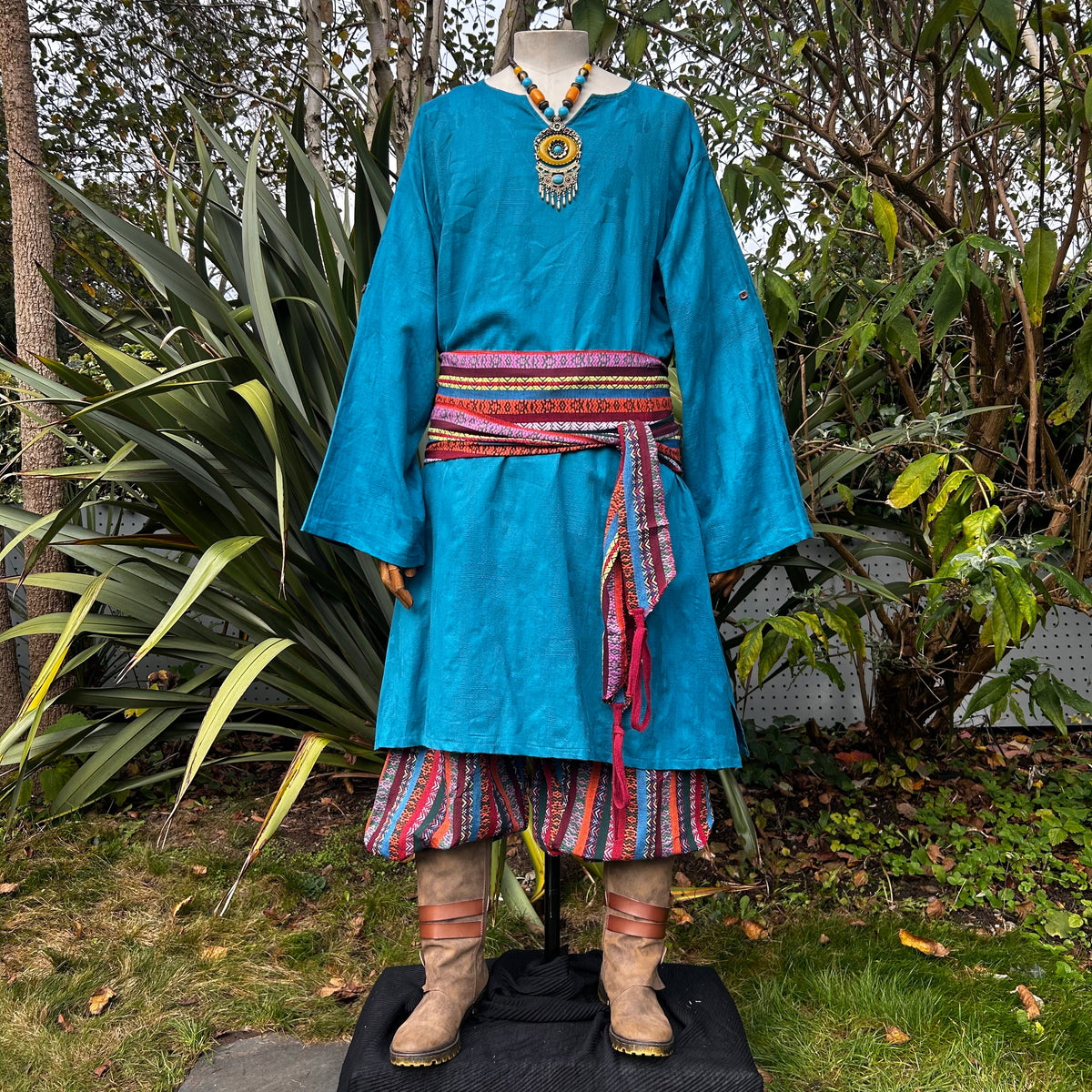 LARP multi stripe pirate sash in vibrant colors over medieval costume.