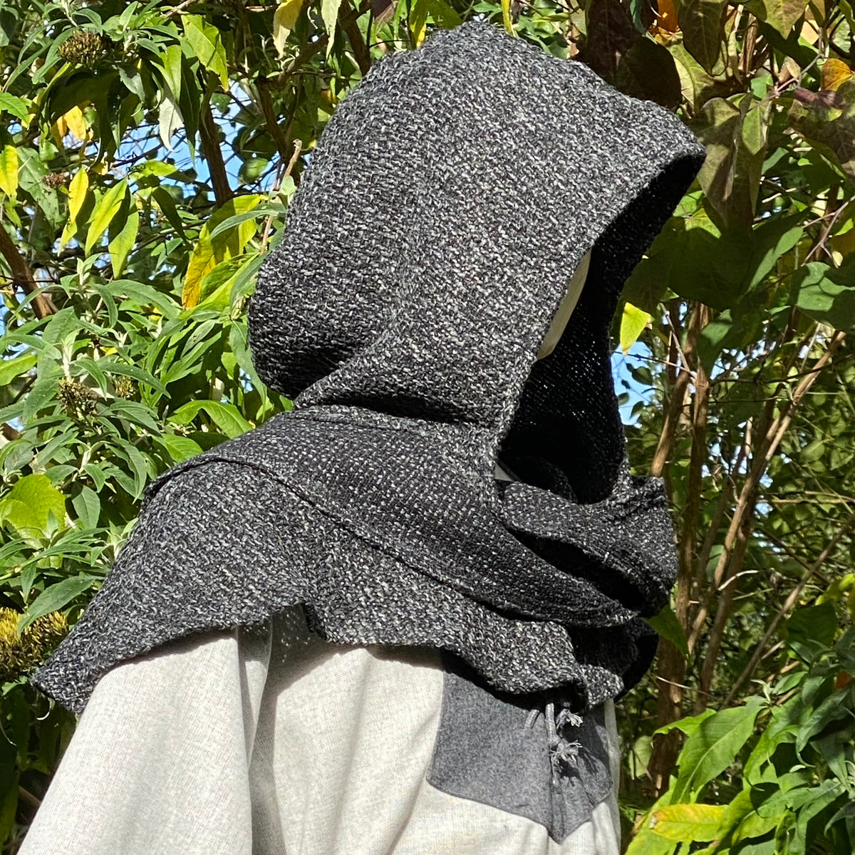 LARP medieval grey hood detail against leafy.