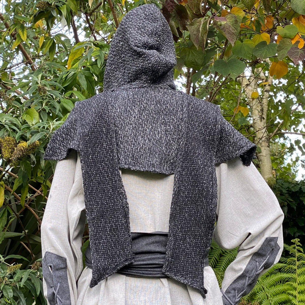 Dark grey LARP robe with hood, textured fabric, rear view amidst greenery.
