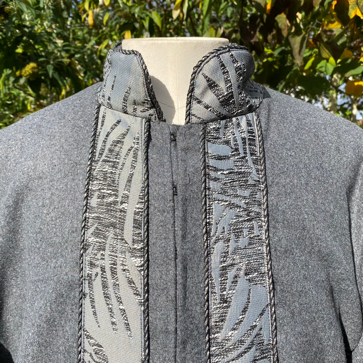 Medieval LARP grey coat with detailed embroidered collar close-up.