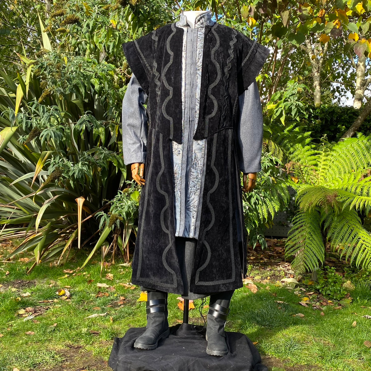 Black and grey medieval LARP costume with long waistcoat and detailing.