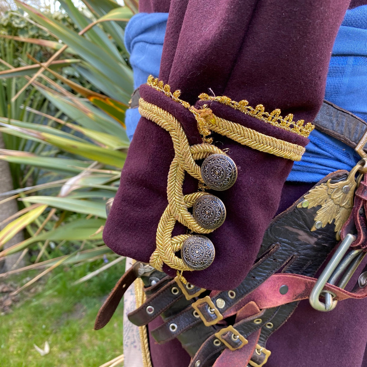 Detailed close-up of LARP pirate coat sleeve with ornate buttons and trim.