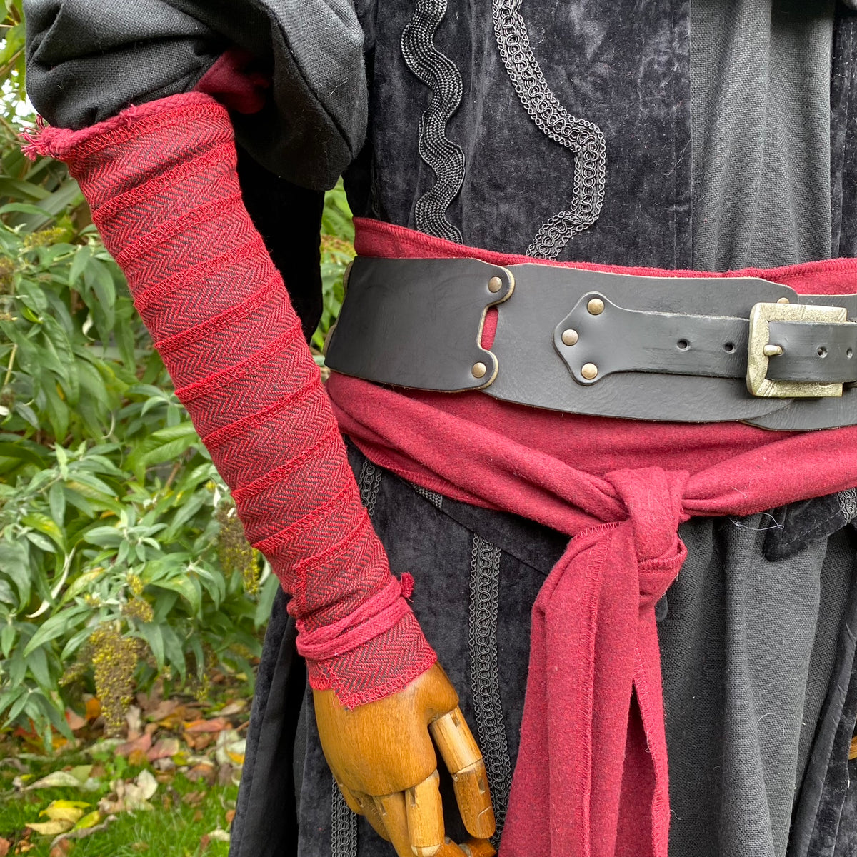 Red herringbone wool arm wrap, close-up, suitable for LARP or medieval attire.