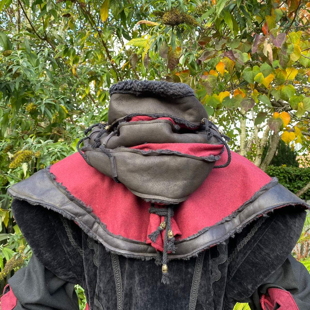 Black and red layered hood with tassels, medieval LARP style, back view.