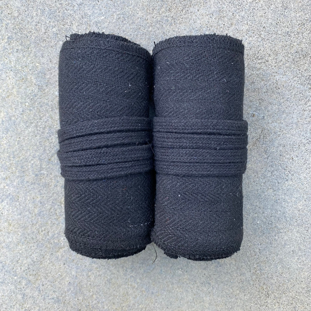 Set of Medieval LARPing Leg Wraps. They are Black and made out of a Herringbone Wool mixture which are used to keep Trouser flares out of the way and legs warm. These Viking Wraps can wrap around your Legs to provide an extra flare to LARP kit.