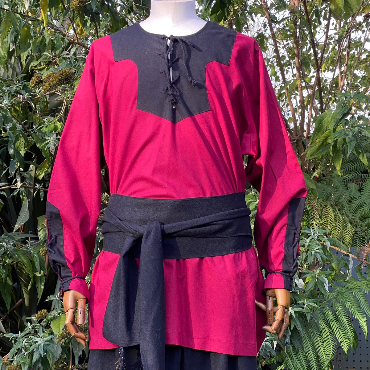 Red and black Blood Mage LARP cloak, shirt, and belt on a mannequin.