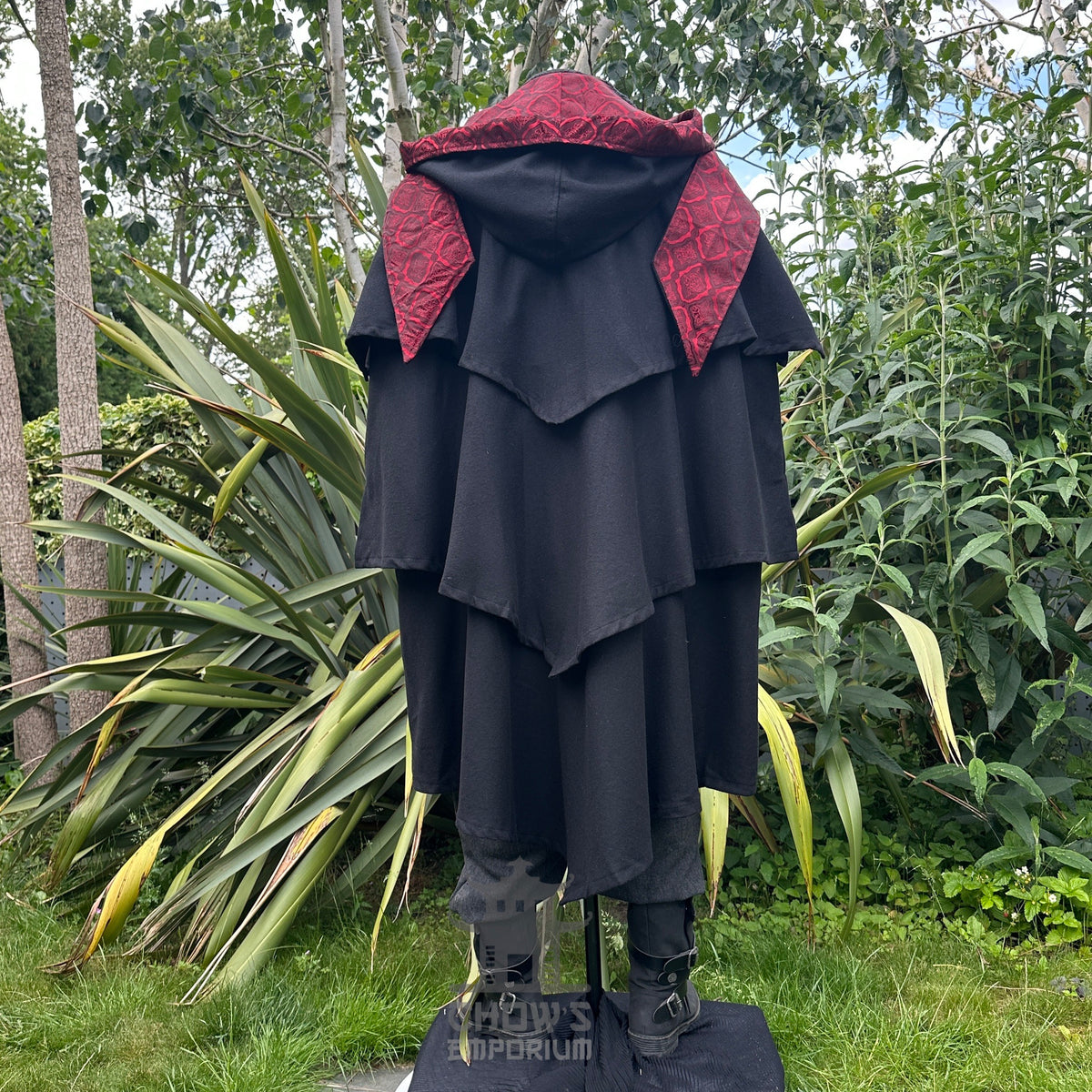 Three-layer black LARP cloak from behind, red hood lining displayed.