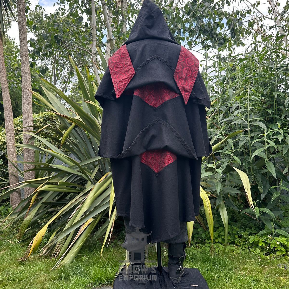 Back view of medieval LARP cloak with hood and red diamond pattern accents.