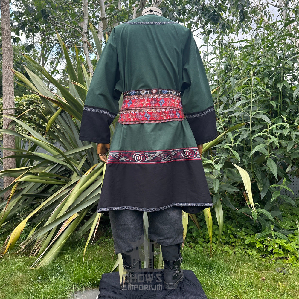 Medieval LARP outfit back view, featuring a green and black Viking tunic, trousers and sash. For Renaissance Faire and historical roleplay events.