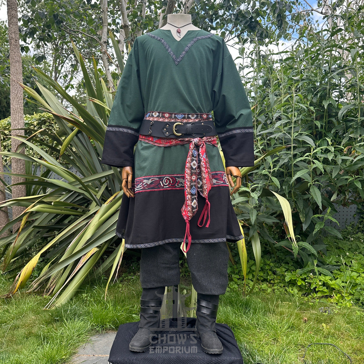 Green and black medieval outfit with red sash.