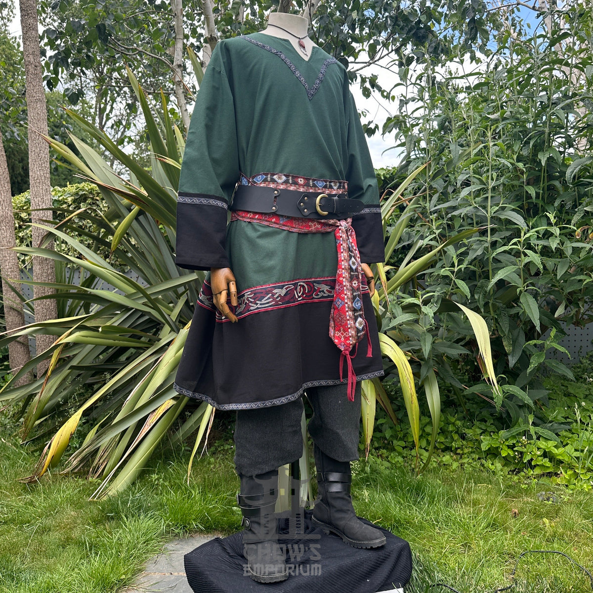 Green and black LARP outfit with tunic, trousers, and red sash.