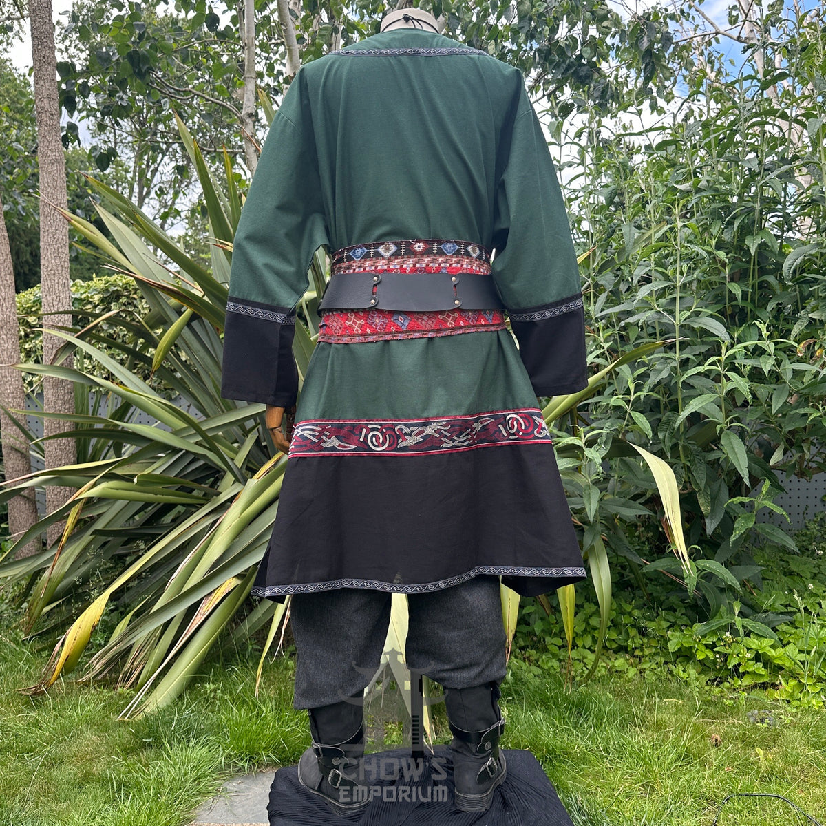 Back view of medieval LARP outfit; green tunic with red patterns and sash.