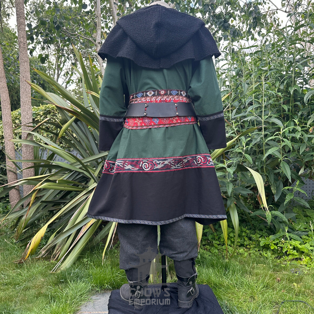 LARP medieval outfit with green tunic, black hood, trousers, and sash. Back view.
