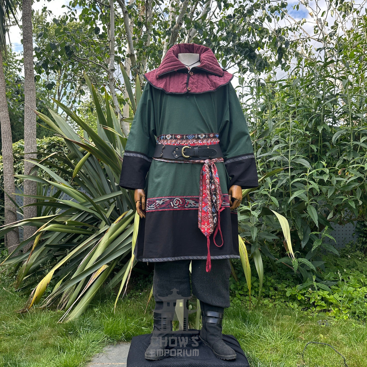 LARP medieval outfit, front view: green tunic, black hood, trousers, and sash.