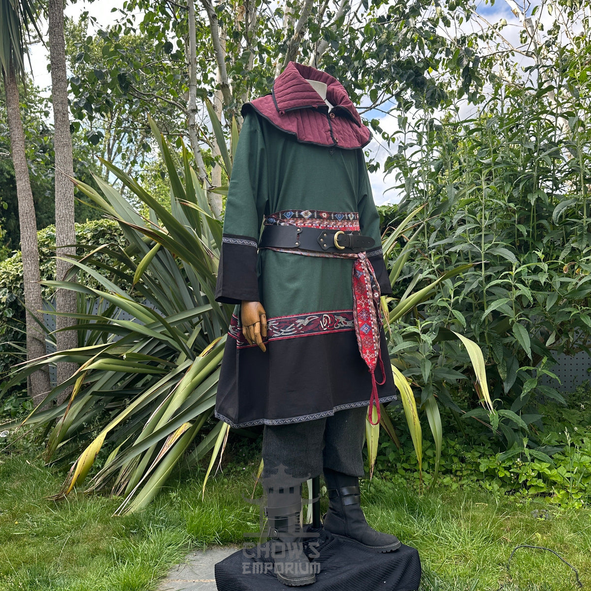 LARP medieval outfit with green tunic, black trousers, red sash, and hood.