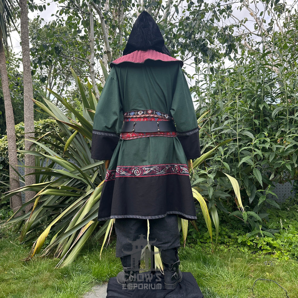 Medieval LARP outfit back view, featuring a green and black Viking tunic, gambeson hood, trousers and sash. For Renaissance Faire and historical roleplay events.