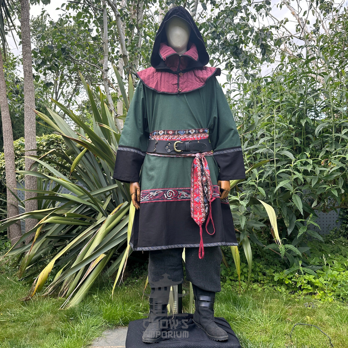 Green and black LARP outfit with tunic, gambeson hood, trousers, sash.