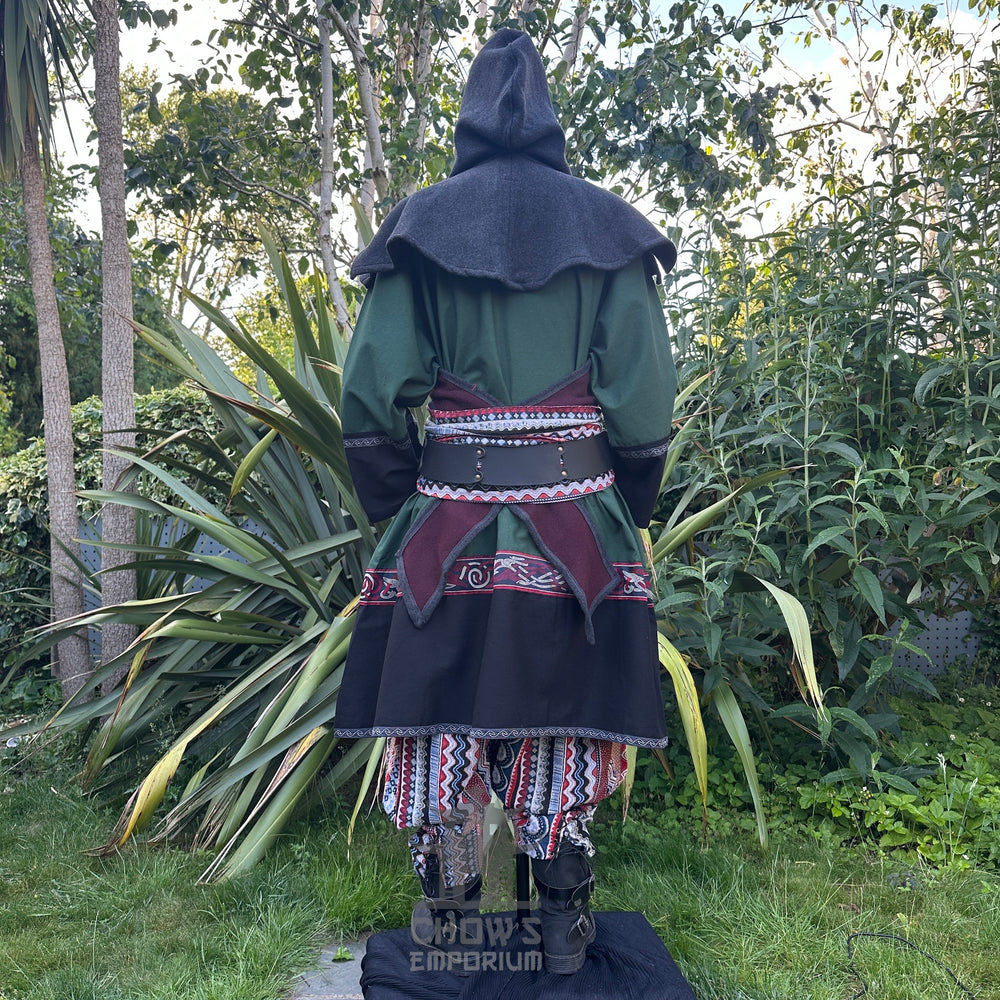 Medieval LARP outfit back view, featuring a green and black Viking tunic, reversible hood, trousers and sash. For Renaissance Faire and historical roleplay events.