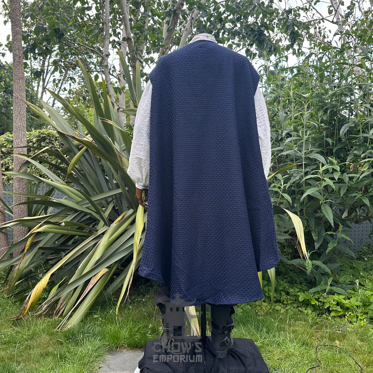 Back view of pirate waistcoat with loose flowing panels and blue sash.