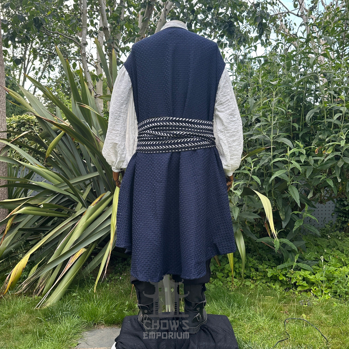Back view of blue and white LARP pirate waistcoat showing flowing panel design and sash detail.