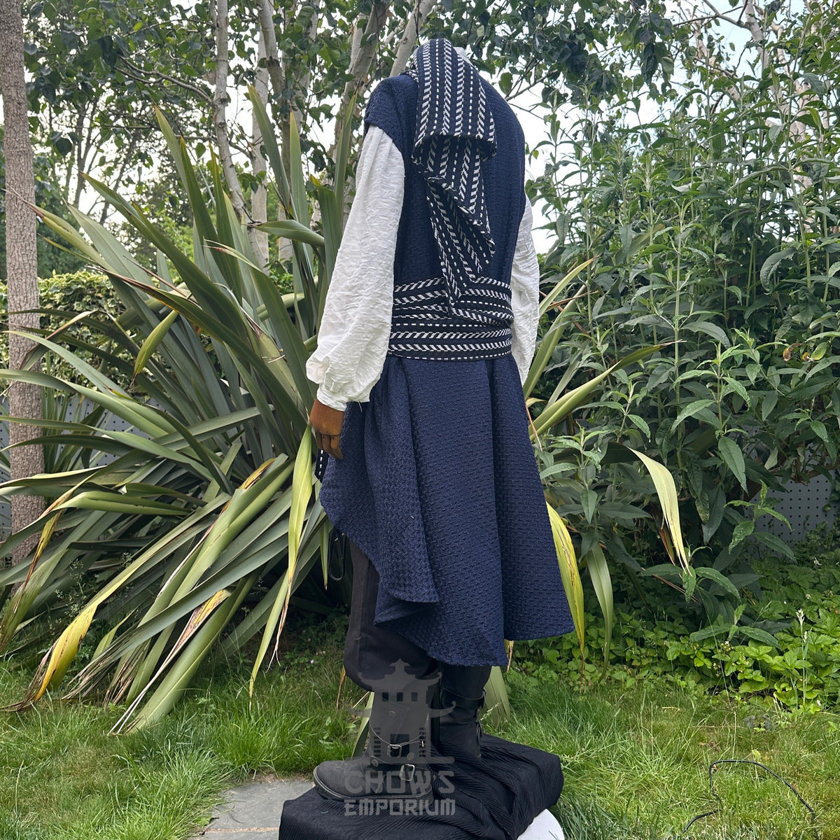Medieval LARP costume side view, includes blue and white waistcoat with asymmetrical front.
