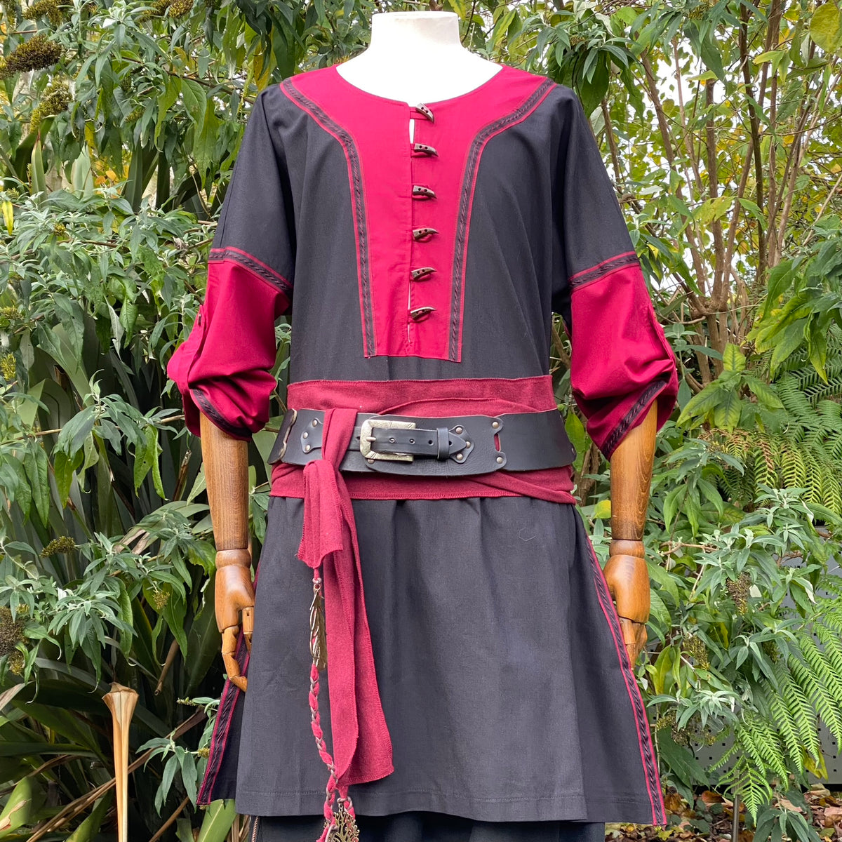 Mannequin in black-red medieval LARP tunic with a detailed belt.