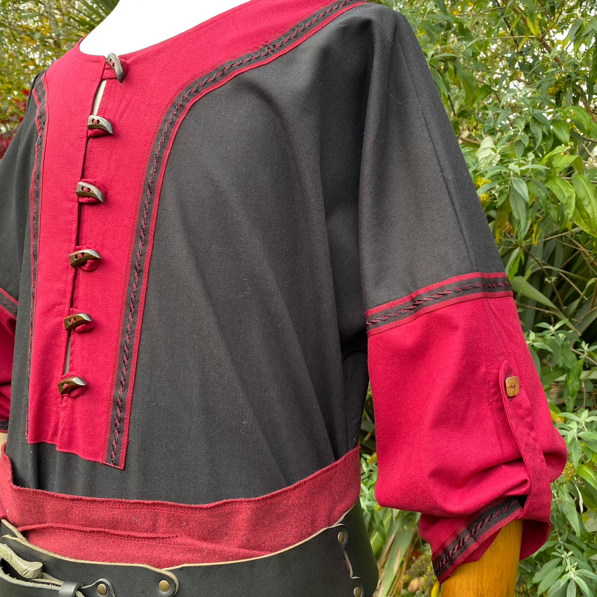 Red and black medieval tunic detail with decorative buttons for LARP.