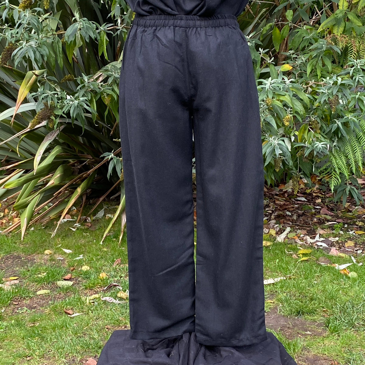 black wool fantasy pants with straight silhouette.