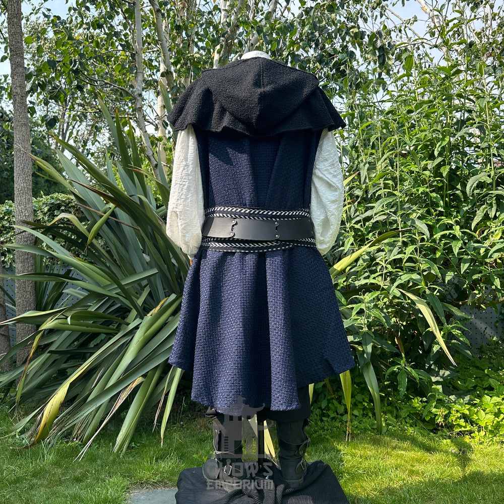 Medieval LARP outfit back view, featuring blue asymmetrical waistcoat, hood, shirt, trousers, sash and necklace. For Renaissance Faire and historical roleplay events.