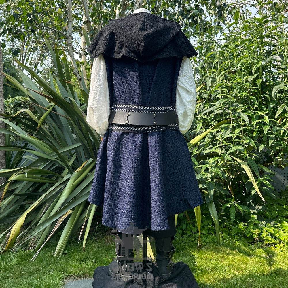 Medieval LARP costume back view, includes blue and white waistcoat with asymmetrical front panel and matching sash, wool hood, shirt and trousers for Ren Faire and roleplay events.